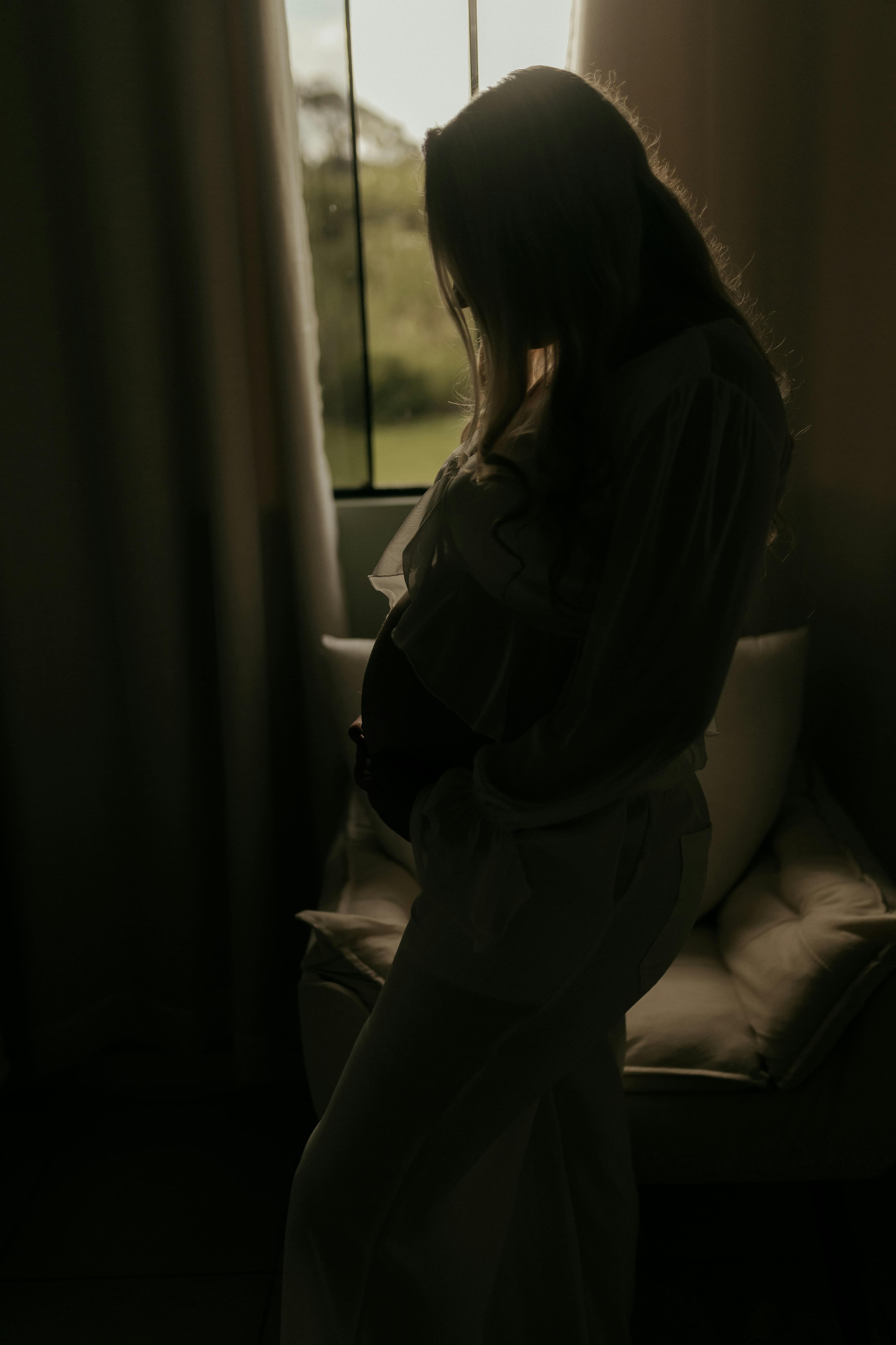 A pregnant woman in soft light