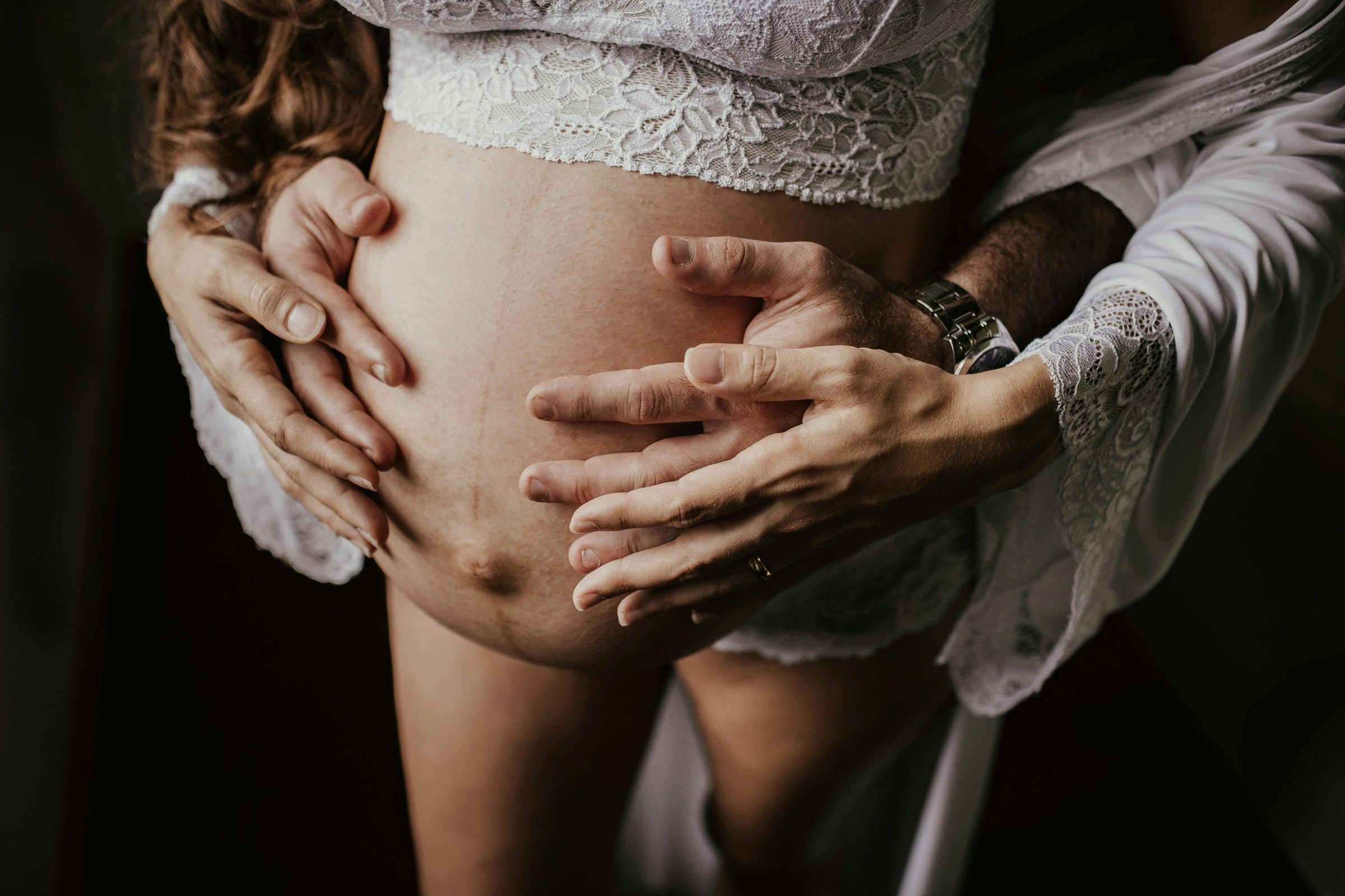 Hands resting on a pregnant belly